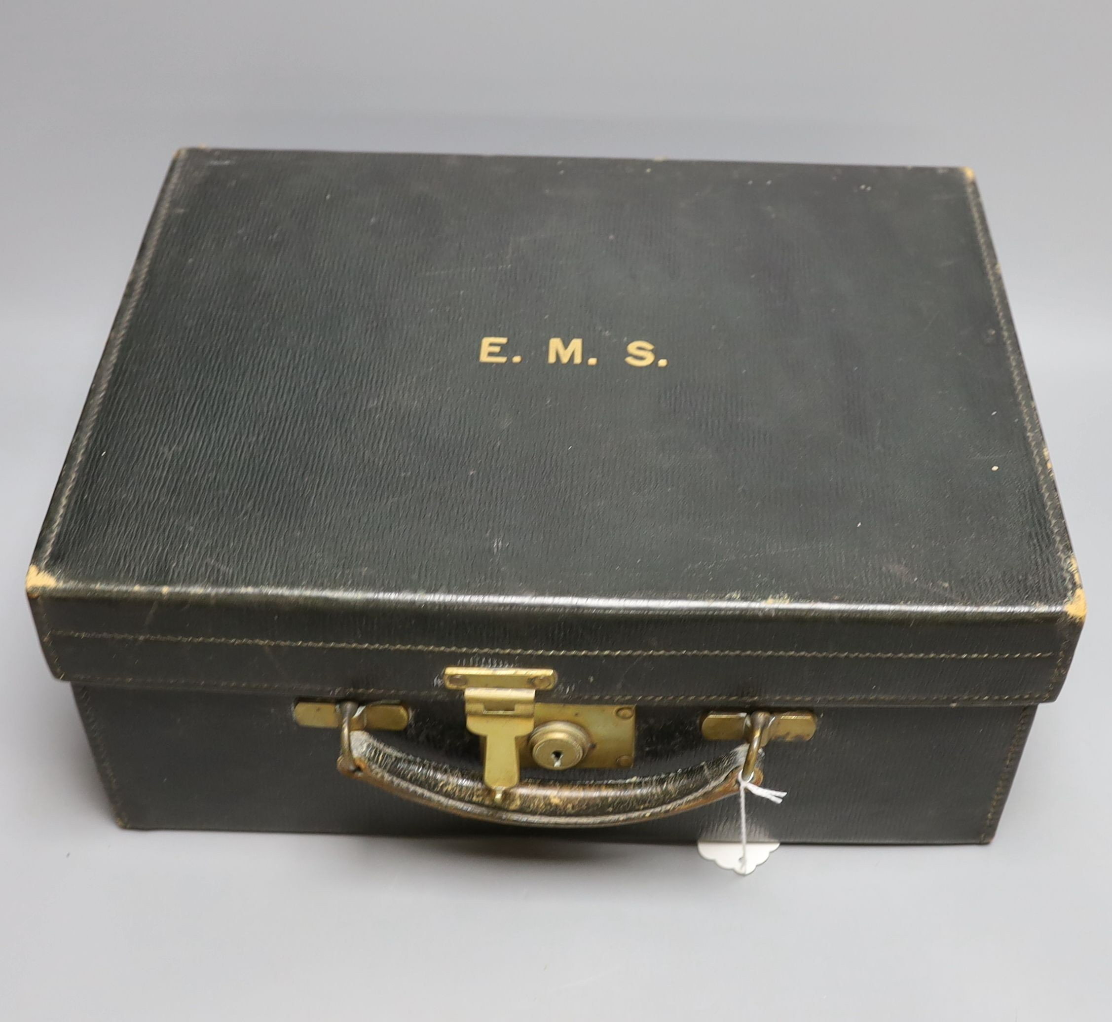 An early 20th century travelling toilet case by Cornhill, London, with seven harlequin silver mounted toilet jars, nail implements and leather stationary case, various dates and makers.